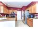 Kitchen features stainless steel appliances, granite countertops, and tile floors at 3292 Covered Bridge E Dr, Dunedin, FL 34698