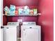 The laundry room features a washer, dryer, and storage shelves at 3292 Covered Bridge E Dr, Dunedin, FL 34698