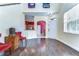 Living room features hardwood floors, neutral paint, and a kitchen view at 3292 Covered Bridge E Dr, Dunedin, FL 34698