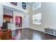 Living room features hardwood floors, neutral paint, and large window at 3292 Covered Bridge E Dr, Dunedin, FL 34698