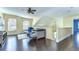 Upstairs loft area features a ceiling fan, wood floors, and natural light at 3292 Covered Bridge E Dr, Dunedin, FL 34698