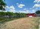 A spacious backyard with a fence, storage shed, and a view of the waterway at 3301 Elkridge Dr, Holiday, FL 34691