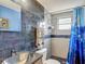 Updated bathroom featuring mosaic tile, modern fixtures, and a glass-enclosed shower at 3301 Elkridge Dr, Holiday, FL 34691