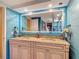 Stylish bathroom featuring a double vanity, framed mirror and blue walls at 3301 Elkridge Dr, Holiday, FL 34691