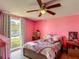 Bright bedroom with hardwood floors, large window, and a ceiling fan at 3301 Elkridge Dr, Holiday, FL 34691