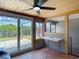 Bright sunroom with wood-paneled ceiling, ceiling fan, and a backyard view at 3301 Elkridge Dr, Holiday, FL 34691