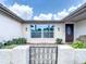 Inviting entrance features a decorative gate, neutral paint, and updated exterior lighting at 3301 Elkridge Dr, Holiday, FL 34691