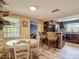 Open kitchen with dining area features a breakfast bar, pendant lighting, and modern flooring at 3301 Elkridge Dr, Holiday, FL 34691