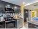 Open kitchen featuring stainless steel appliances, mosaic backsplash, and ample cabinet space at 3301 Elkridge Dr, Holiday, FL 34691