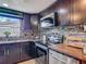 Modern kitchen featuring stainless steel appliances, mosaic backsplash, and ample counter space at 3301 Elkridge Dr, Holiday, FL 34691
