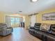Comfortable living room with tile floors, slider doors to porch, and well-decorated neutral interior at 3301 Elkridge Dr, Holiday, FL 34691