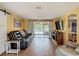 Spacious living room with tile floors, slider doors to the porch, and comfortable seating at 3301 Elkridge Dr, Holiday, FL 34691