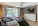 Comfortable main bedroom with a dresser and TV, offering a relaxing retreat at 3301 Elkridge Dr, Holiday, FL 34691