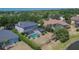 Aerial view of a home with screened pool, lush backyard, and pond at 3314 Cypress Landing Dr, Valrico, FL 33596