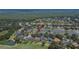 A bird's eye view showing a lakefront house with a screened-in pool in the backyard at 3314 Cypress Landing Dr, Valrico, FL 33596