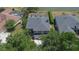 An aerial view reveals the home's front entrance, driveway, and mature tree coverage at 3314 Cypress Landing Dr, Valrico, FL 33596