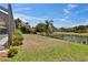 A fenced-in backyard featuring a serene pond view and lush landscaping at 3314 Cypress Landing Dr, Valrico, FL 33596