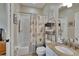 Well-lit bathroom with a shower-tub combination, seashell themed shower curtain, and granite vanity at 3314 Cypress Landing Dr, Valrico, FL 33596