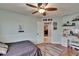 Bright bedroom with wood floors, ceiling fan and vanity at 3314 Cypress Landing Dr, Valrico, FL 33596