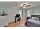 Bedroom with wood floors, ceiling fan, natural light, closet and attached bath at 3314 Cypress Landing Dr, Valrico, FL 33596