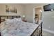 Comfortable bedroom featuring a wooden bed frame, side table and a view into the en-suite bathroom at 3314 Cypress Landing Dr, Valrico, FL 33596