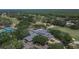 Aerial image showcasing a clubhouse overlooking a golf course in a lush, wooded community at 3314 Cypress Landing Dr, Valrico, FL 33596