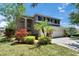 Two-story home featuring a three-car garage, landscaping, and trimmed lawn at 3314 Cypress Landing Dr, Valrico, FL 33596