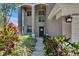 Close up on the front entrance featuring a pathway lined with lush landscaping at 3314 Cypress Landing Dr, Valrico, FL 33596