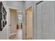 Bright hallway with tiled floors featuring multiple doorways, enhancing the flow of the home at 3314 Cypress Landing Dr, Valrico, FL 33596