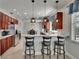 An open kitchen boasts granite counters, stainless appliances, pendant lighting, and breakfast bar seating at 3314 Cypress Landing Dr, Valrico, FL 33596