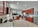 An open kitchen shows stainless appliances, granite countertops, and opens to an airy living space at 3314 Cypress Landing Dr, Valrico, FL 33596