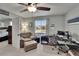 Office area features a comfortable chair and ottoman, a large window and a ceiling fan at 3314 Cypress Landing Dr, Valrico, FL 33596
