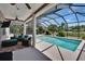 Relaxing outdoor pool area with screened-in enclosure, comfortable seating, and green landscaping at 3314 Cypress Landing Dr, Valrico, FL 33596