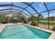 A refreshing screened-in pool with lush green landscaping and a clear blue sky at 3314 Cypress Landing Dr, Valrico, FL 33596