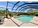 Clear pool with screened-in enclosure, patio furniture, and manicured landscaping at 3314 Cypress Landing Dr, Valrico, FL 33596
