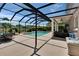 Screened-in pool area with seating, dining table, and hot tub at 3314 Cypress Landing Dr, Valrico, FL 33596