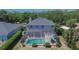 A home with a screened-in pool and jacuzzi is surrounded by lush landscaping at 3314 Cypress Landing Dr, Valrico, FL 33596