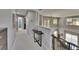 Carpeted upstairs hallway with views of the downstairs area, multiple doorways, and ample natural light at 3314 Cypress Landing Dr, Valrico, FL 33596