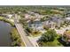 A waterfront home near a bridge features solar panels, manicured lawns, and picturesque water access at 339 Manatee Ln, Tarpon Springs, FL 34689