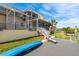 Spacious backyard with a dock and stairs leading to the water at 339 Manatee Ln, Tarpon Springs, FL 34689