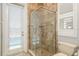 A bathroom with a glass shower enclosure and view of the sliding glass door and window at 339 Manatee Ln, Tarpon Springs, FL 34689