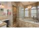 Bright bathroom with a large soaking tub beneath arched windows, and a tiled shower at 339 Manatee Ln, Tarpon Springs, FL 34689