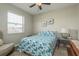 This bedroom has an inviting bed with bright bedding and a ceiling fan overhead at 339 Manatee Ln, Tarpon Springs, FL 34689