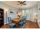 Dining room with a wood table, blue chairs, and a bay window offering natural light at 339 Manatee Ln, Tarpon Springs, FL 34689