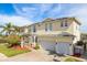 Two story home with 3 car garage, lush landscaping and a paver driveway at 339 Manatee Ln, Tarpon Springs, FL 34689