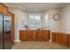 A spacious kitchen nook with custom wood cabinetry, a stainless steel refrigerator and a view of the backyard at 339 Manatee Ln, Tarpon Springs, FL 34689