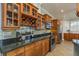 A kitchen featuring granite countertops, stainless steel appliances, and custom wood cabinetry with a built-in wine rack at 339 Manatee Ln, Tarpon Springs, FL 34689