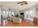 Cozy living room featuring a fireplace, wood floors, and lots of natural light at 339 Manatee Ln, Tarpon Springs, FL 34689