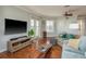 Open concept living room with hardwood floors and French doors, perfect for entertaining at 339 Manatee Ln, Tarpon Springs, FL 34689