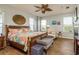 Bright main bedroom with wood floors, stylish decor, and ample natural light at 339 Manatee Ln, Tarpon Springs, FL 34689